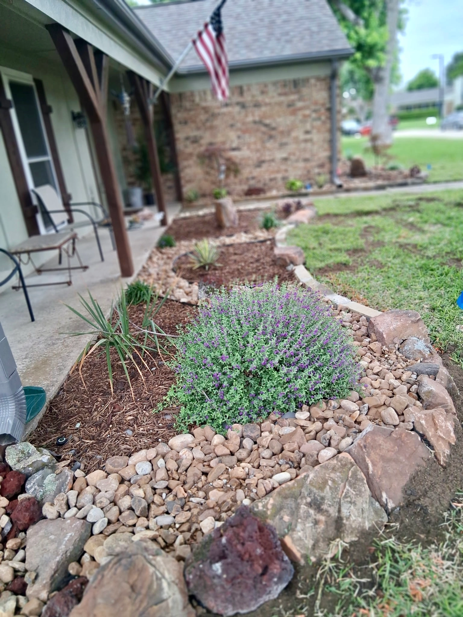 Dry creek bed and river rock flower bed in Richardson, TX