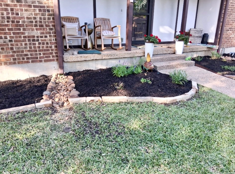 New mulch bed with decorative drainage in Richardson, TX