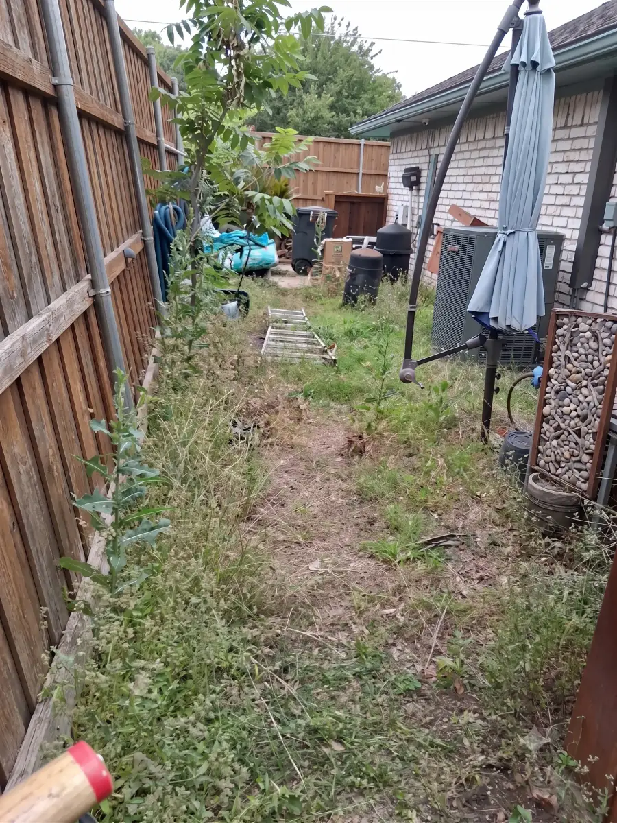 Before: bare side yard prior to turf and putting green installation in Dallas, TX